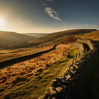 Panoramic view of a dry stone wall in rolling hills at sunset. - Image 3