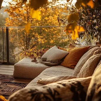 Outdoor terrace with cushions and throws surrounded by vibrant autumn leaves - Image 1