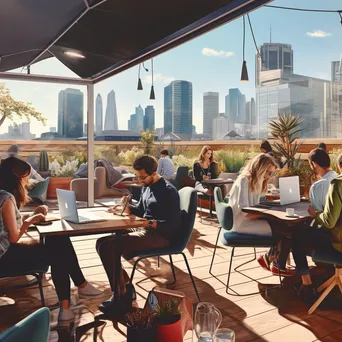 Professionals working on laptops in a rooftop co-working space - Image 2