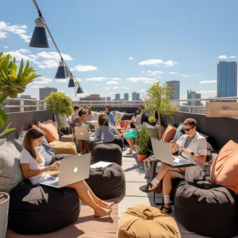 Professionals working on laptops in a rooftop co-working space - Image 3