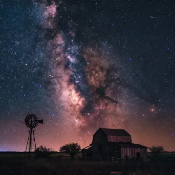 Milky Way galaxy over peaceful farm with barn and windmill - Image 1