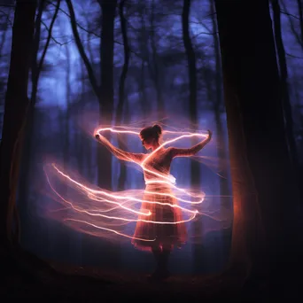 Dancer with LED sticks creating light trails in a dark forest. - Image 1