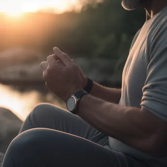 Person meditating in nature while wearing smartwatch - Image 2