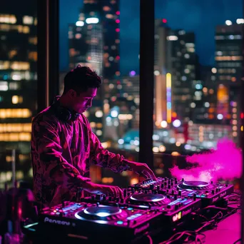 DJ performing at a rooftop party with city skyline backdrop. - Image 2