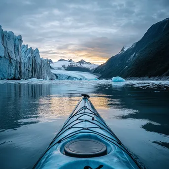 Kayak gliding through icy waters near towering glaciers - Image 3