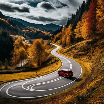 Stylish van parked along a winding road covered in autumn leaves - Image 4