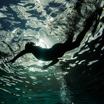 Swimmer diving into crystal clear pool with water ripples - Image 4