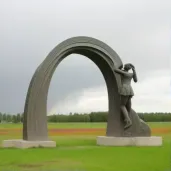 Woman in vibrant meadow looking at rainbow in the sky - Image 1