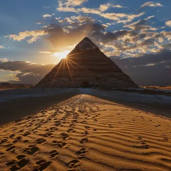 Ancient Egyptian pyramid casting shadows in the desert at sunset - Image 1