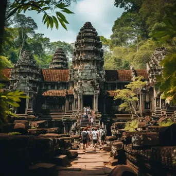 Angkor Wat temple complex in jungle with tourists exploring - Image 2