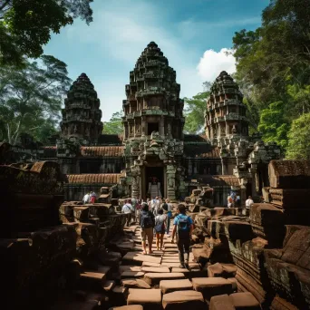 Angkor Wat temple complex in jungle with tourists exploring - Image 3