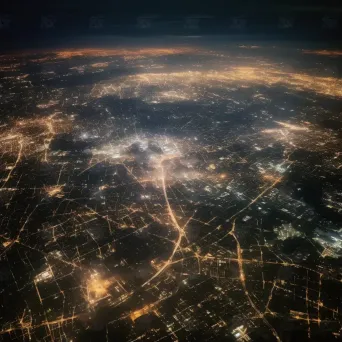 City lights shining brightly at night seen from airplane window - Image 1