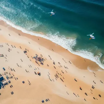 Beach aerial view with helicopters providing surveillance, coastline scene - Image 3