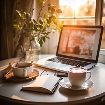 Flat lay of a laptop, notepad, and coffee in a cozy workspace with natural light. - Image 3