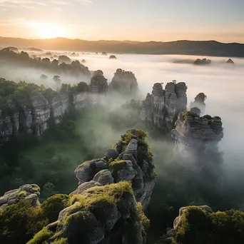 Limestone rock formations at dawn with mist in the valleys. - Image 1