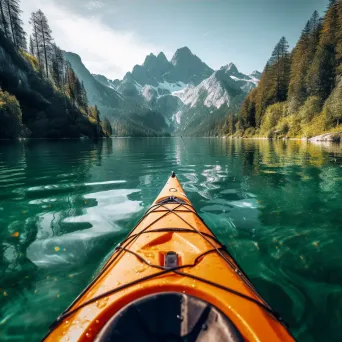 Aerial view of lake with kayak and mountains in background - Image 3