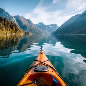 Aerial view of lake with kayak and mountains in background - Image 4