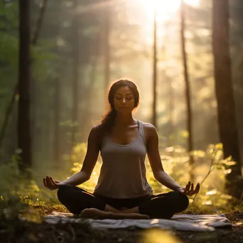 Woman practicing yoga in a forest during morning light. - Image 3