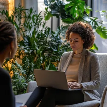 Therapist conducting remote therapy session via laptop - Image 1