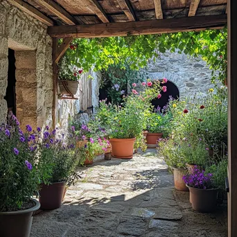 Patio decorated with herbs and root cellar in background. - Image 1