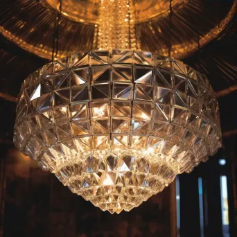 Crystal chandelier with geometric shapes reflecting ambient light - Image 3