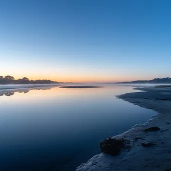 Mist over estuary at dawn where river meets ocean - Image 3