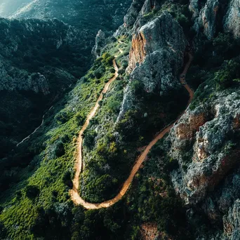 Aerial view of a hiking trail winding through rugged mountainous terrain. - Image 2