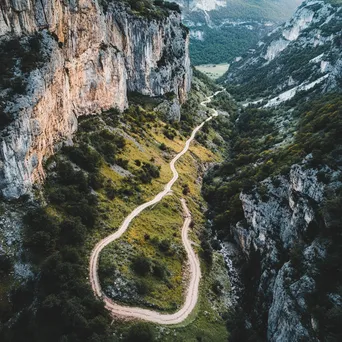 Aerial view of a hiking trail winding through rugged mountainous terrain. - Image 4