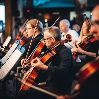 Local community orchestra performance with musicians playing classical music and conductor leading - Image 3