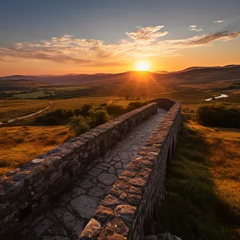 Sunset view from a stone bridge over hills - Image 2