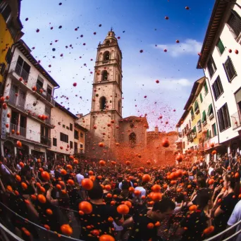 Image of a lively festival where people are throwing tomatoes in a crowded square - Image 2