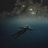 Man Reaching towards Constellation in Celestial Sea