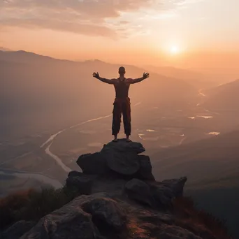 Man practicing yoga on a mountaintop at sunset - Image 3