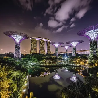 Night view of futuristic Singapore skyline with Marina Bay Sands and SuperTree Grove - Image 2