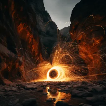 Light trails from spinning steel wool in a canyon landscape. - Image 1