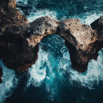 Aerial view of coastal rock arch - Image 4