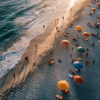 Families enjoying a vibrant sunset beach scene with colorful beach umbrellas and gentle waves. - Image 1