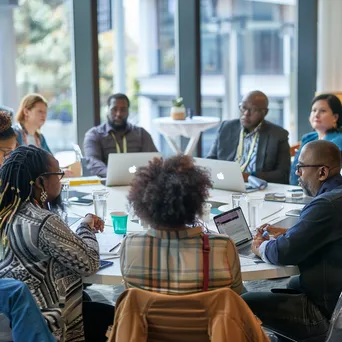 Diverse professionals seated at a round table in a conference session - Image 3