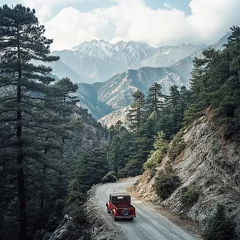 Antique vehicle on steep mountain pass with pine forests - Image 3