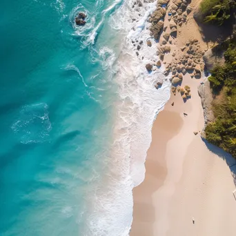 Aerial view of a coastline with turquoise waters and white sands - Image 1