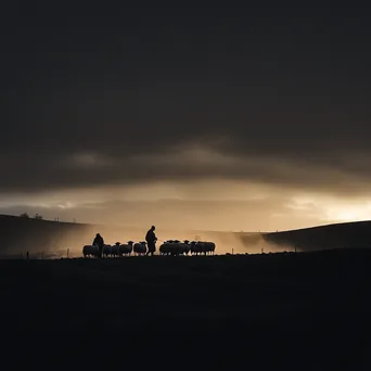 Silhouetted shepherds gathering sheep at twilight - Image 4