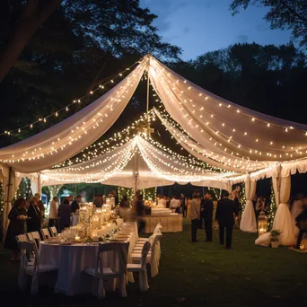 Outdoor wedding reception under a tent - Image 3