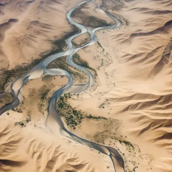 High-resolution satellite image of an arid desert landscape with a winding river, sand dunes, and sparse vegetation. - Image 3