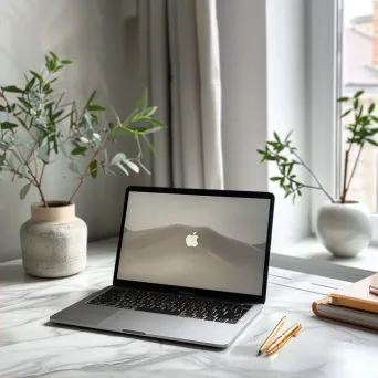 Top-down view of a workspace desk with a laptop, notebooks, pens, and a potted plant - Image 2