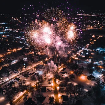 Aerial view of fireworks illuminating a small town