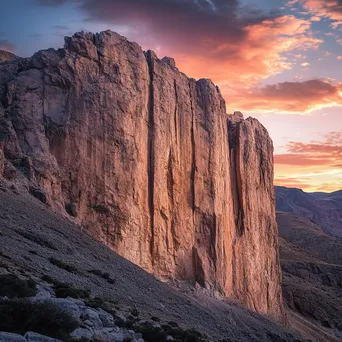 Dramatic mountain rock face during sunset with vibrant colors. - Image 2