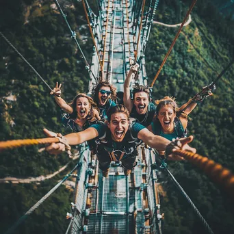 Friends preparing for bungee jump off bridge - Image 1