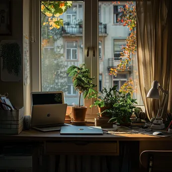 A cozy home office with plants and a laptop in natural light - Image 2