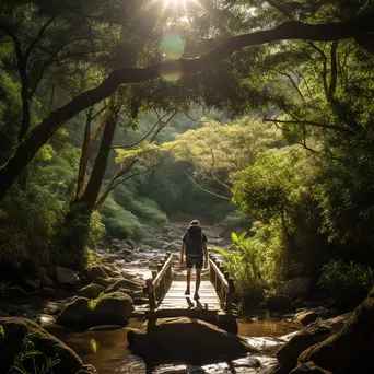 A backpacker crossing a wooden bridge over a stream - Image 3