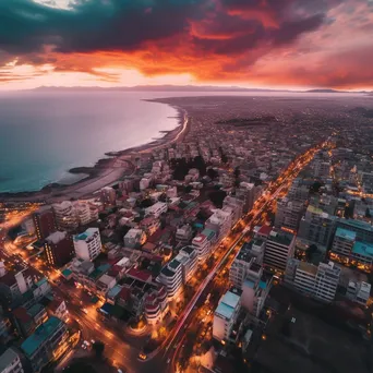 Aerial view of a coastal city at sunset with vibrant architecture - Image 4